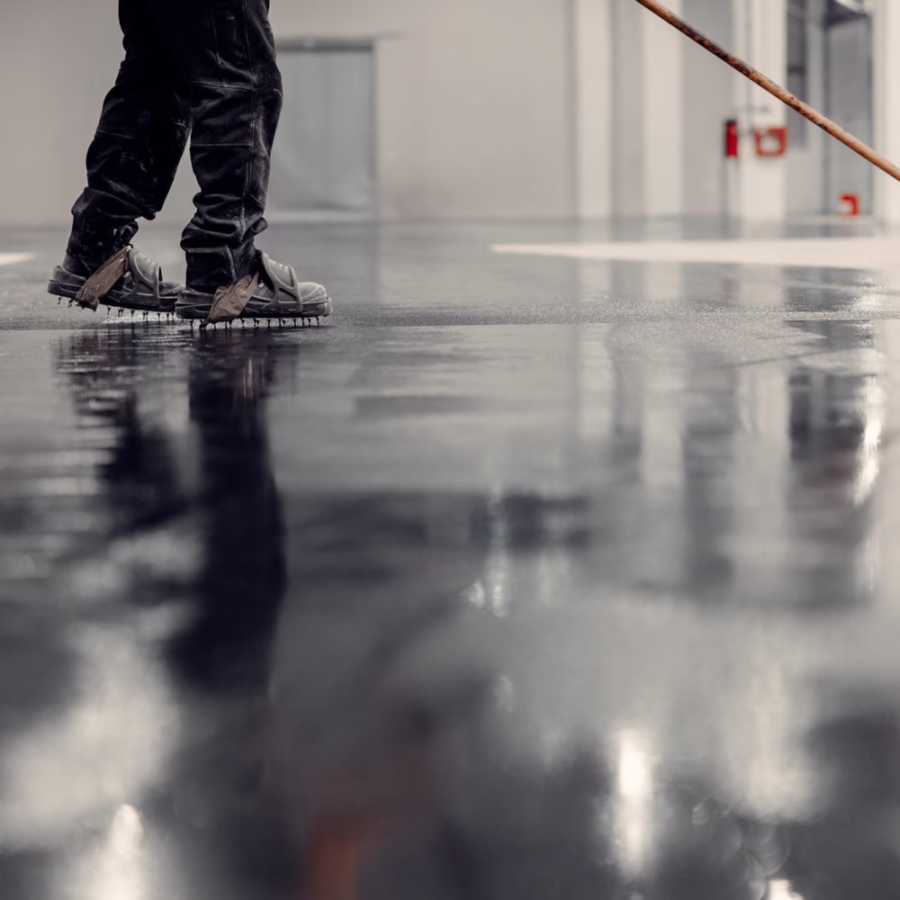 Epoxy floor coating in an industrial warehouse.