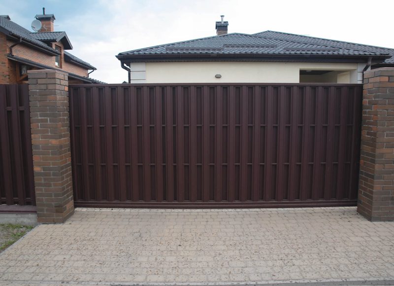 Automatic sliding gates with a metal picket fence